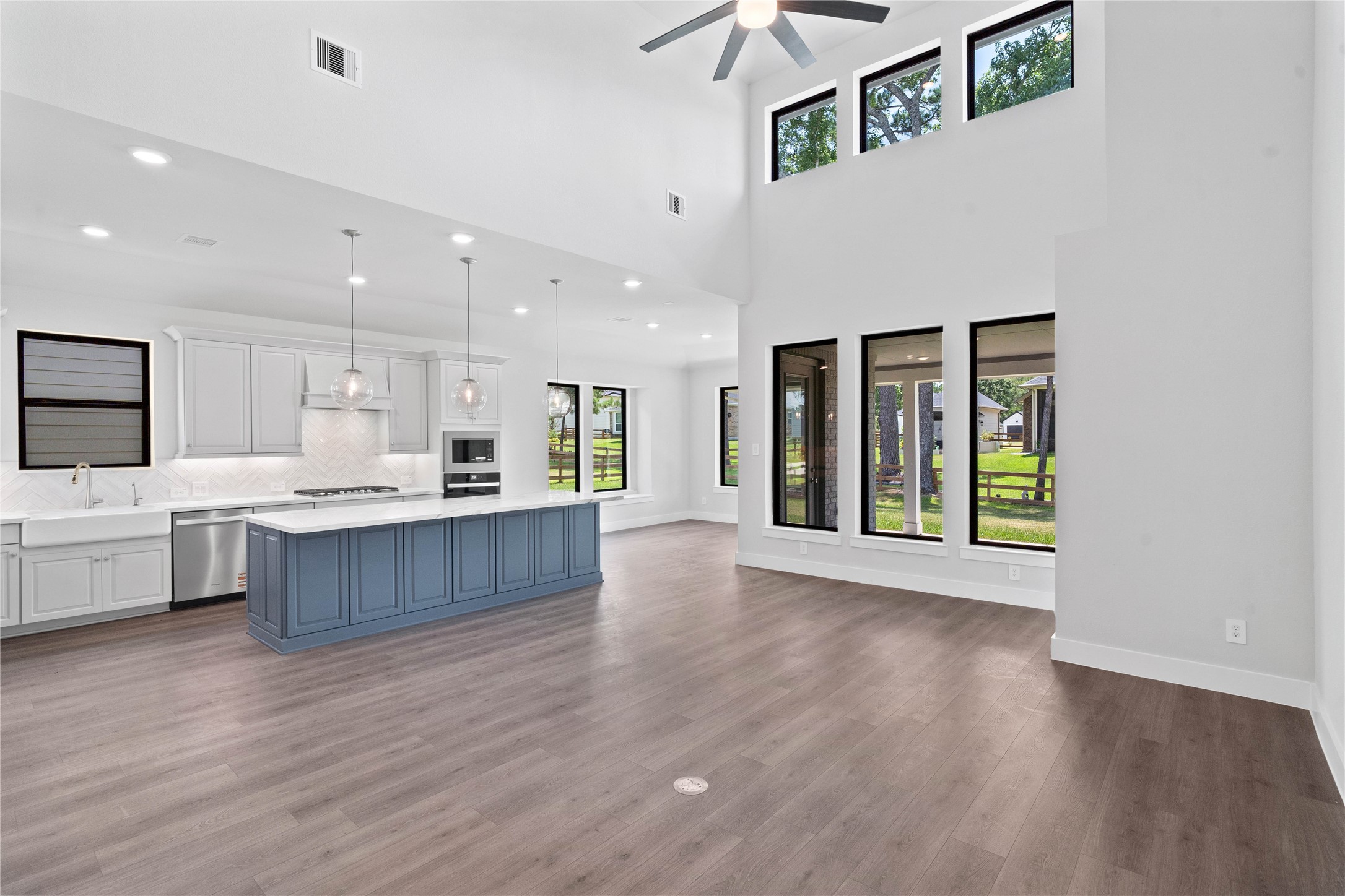 551 Black Bronco Road Magnolia, TX 77354 - Photo 15 of 50 Stunning open-concept design seamlessly connecting the living, dining, and kitchen areas—perfect for both everyday living and entertaining!