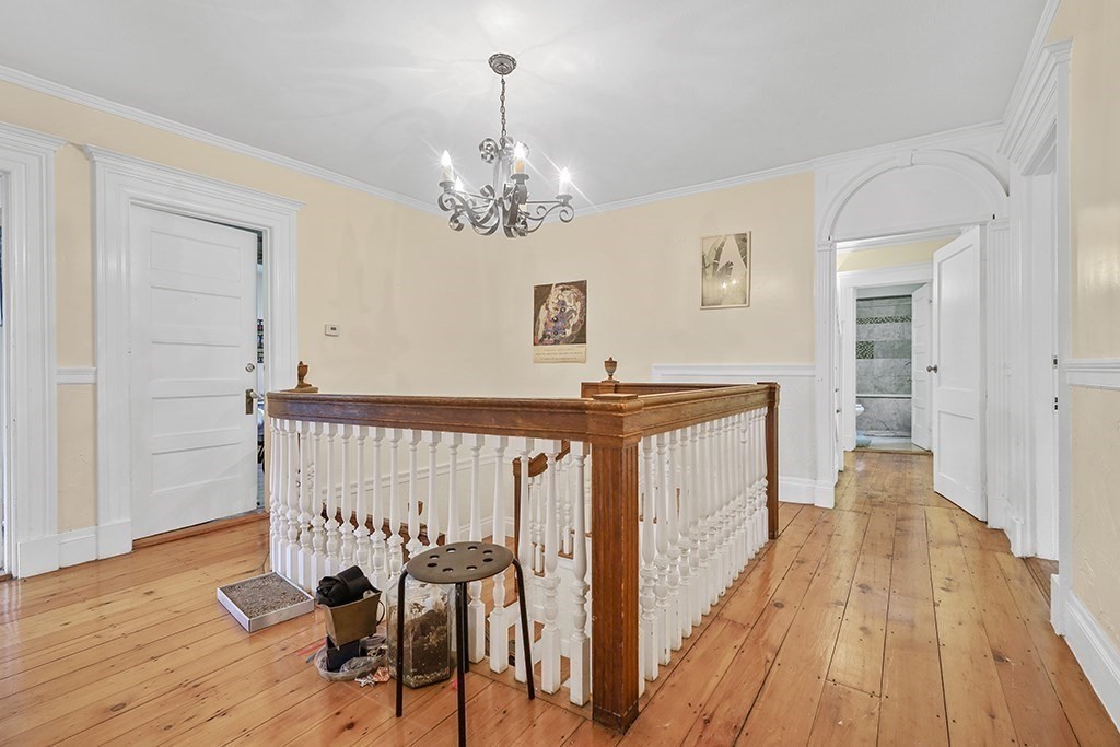 70 Peter Parley Road Boston, MA 02130 - Photo 23 of 35 a view of a hallway with wooden floor and staircase