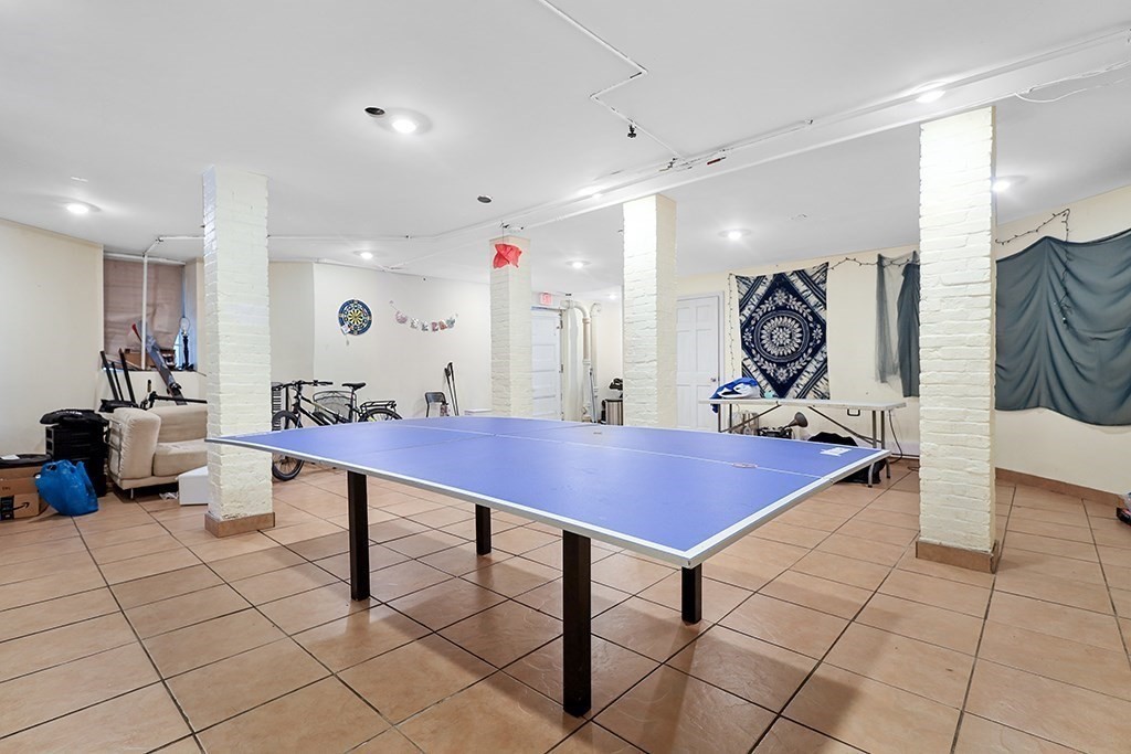 70 Peter Parley Road Boston, MA 02130 - Photo 28 of 35 a living room with furniture a rug and gym equipment