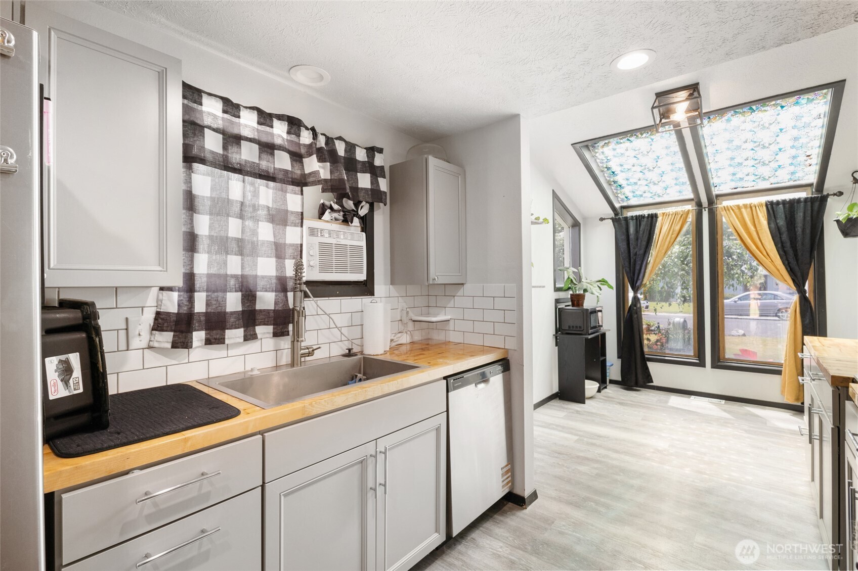 9307 Albert Way Southeast Moses Lake, WA 98837 - Photo 15 of 40 a spacious en suite bathroom with a double vanity sink a mirror and next to a window