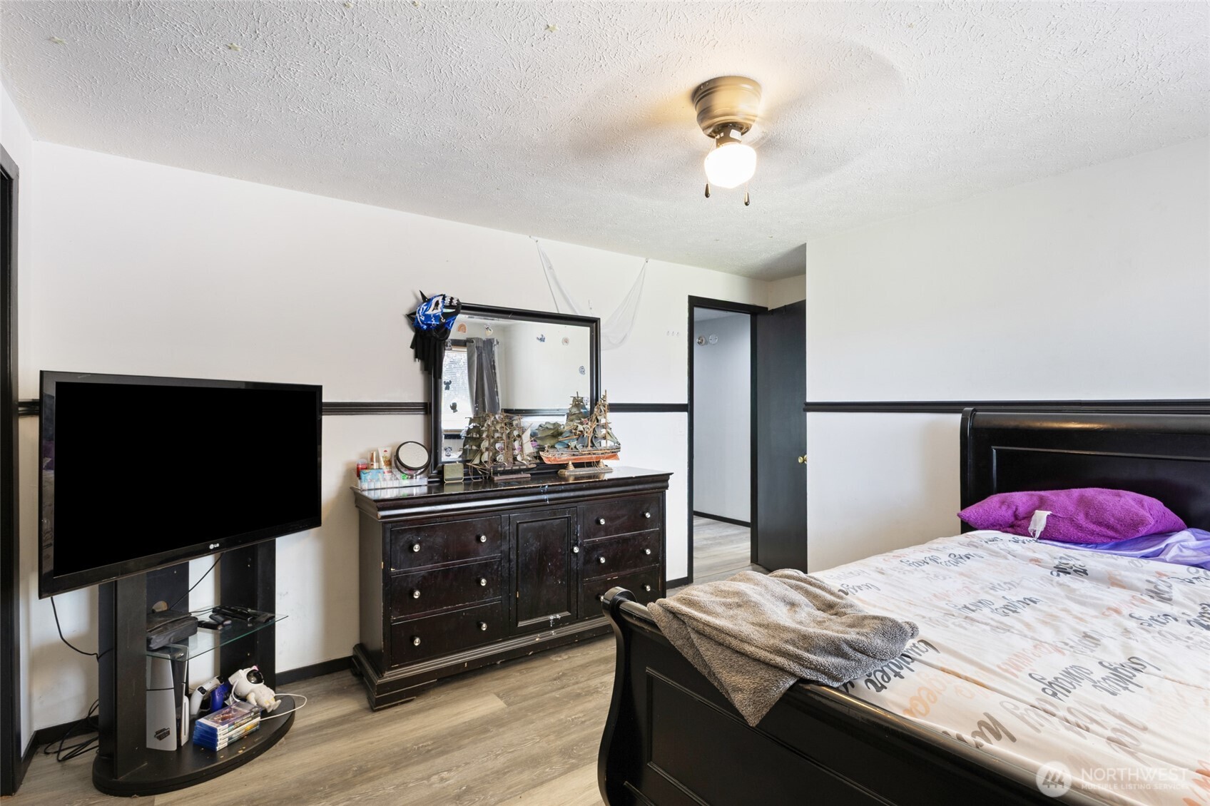 9307 Albert Way Southeast Moses Lake, WA 98837 - Photo 25 of 40 a bedroom with a bed and a flat tv screen on dresser