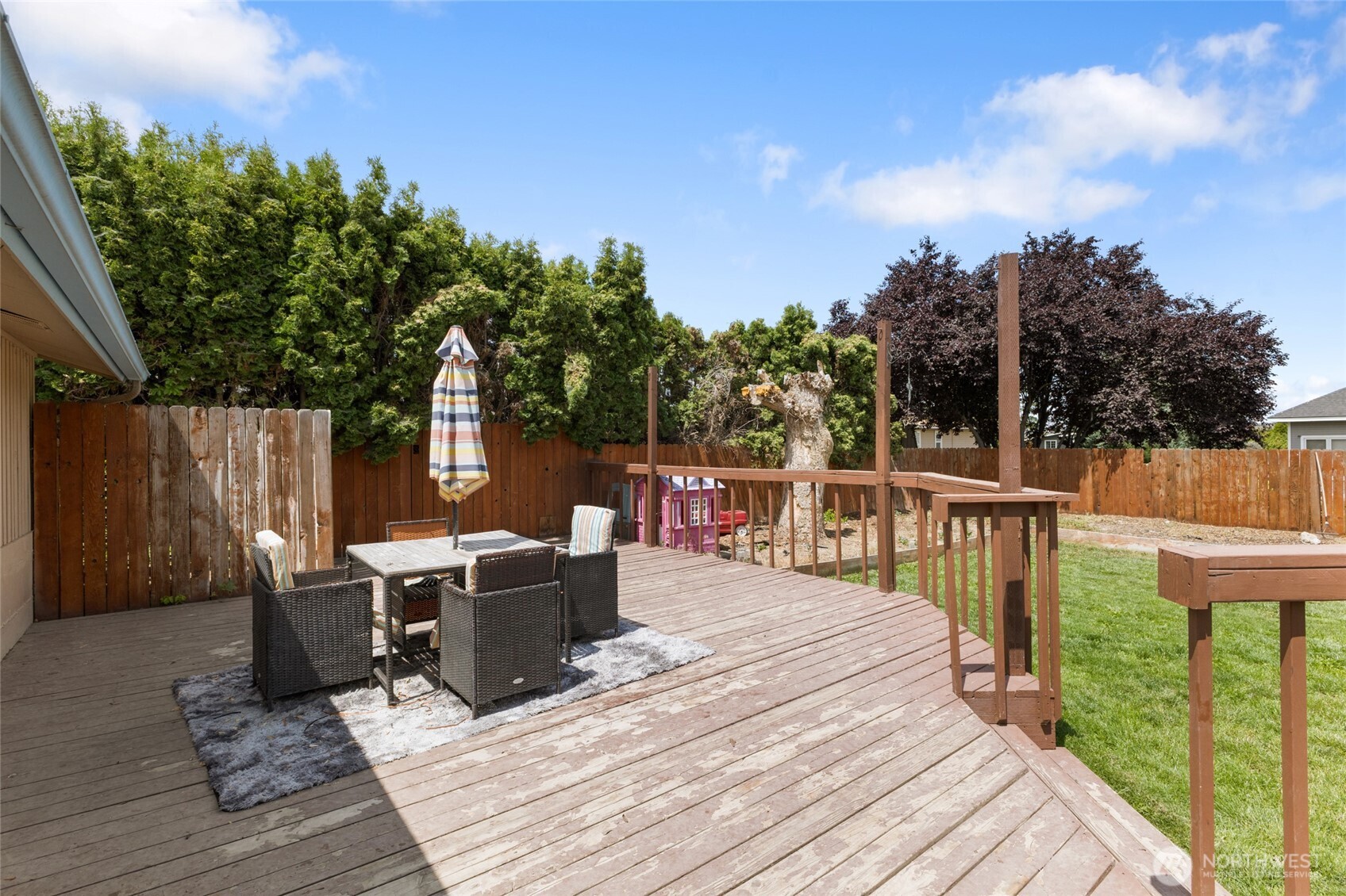 9307 Albert Way Southeast Moses Lake, WA 98837 - Photo 32 of 40 a view of a deck with furniture and a garden