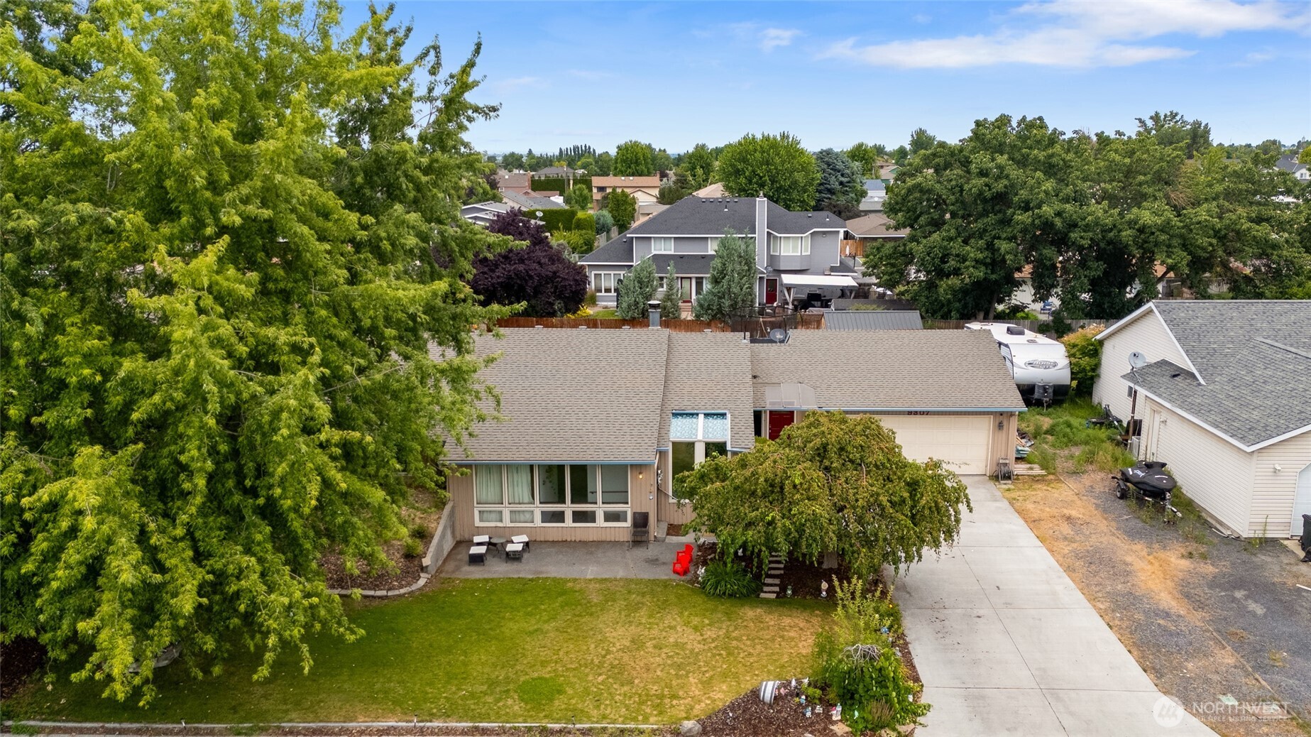 9307 Albert Way Southeast Moses Lake, WA 98837 - Photo 5 of 40 an aerial view of a house with a yard basket ball court and outdoor seating