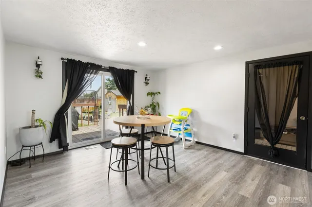 a view of a room with furniture and wooden floor
