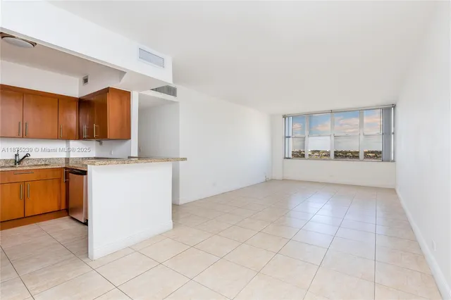 a kitchen with a stove a sink and a refrigerator