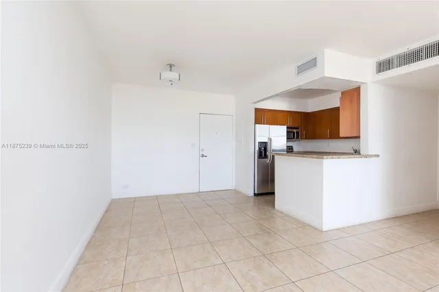 a view of kitchen with cabinets and window