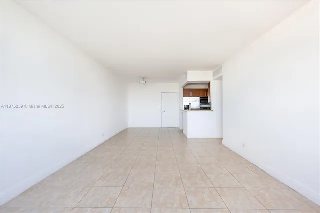 an empty room with white wall and stairs