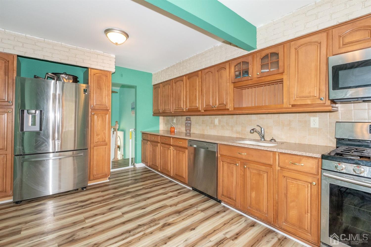 4 Hansen Road Old Bridge, NJ 08857 - Photo 13 of 39 a kitchen with stainless steel appliances granite countertop a refrigerator a stove top oven a sink and dishwasher