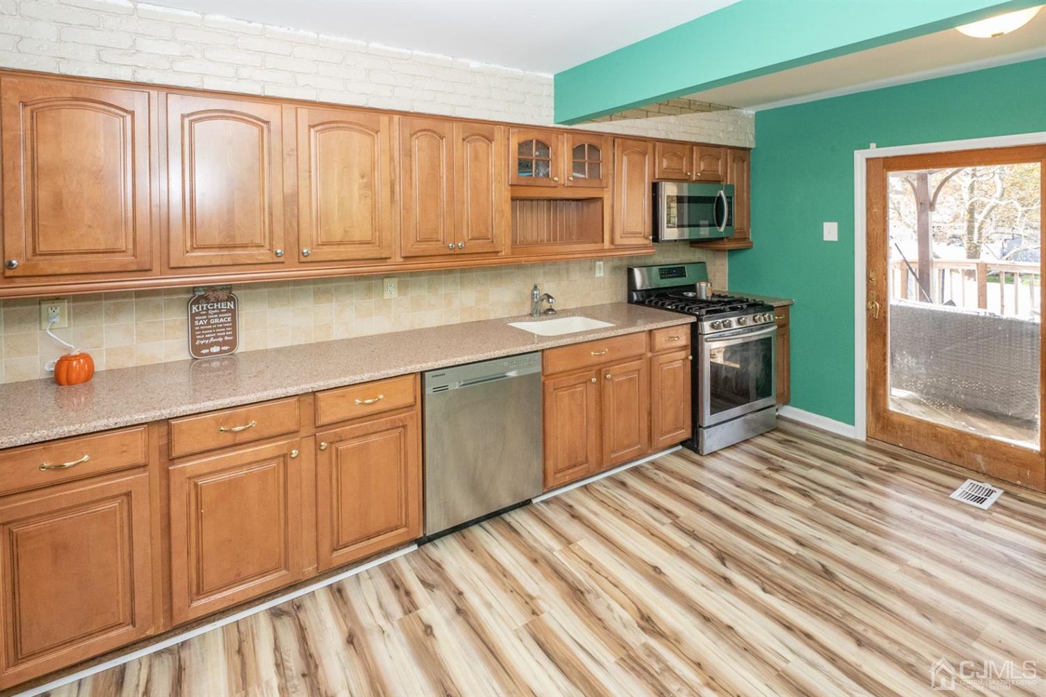 4 Hansen Road Old Bridge, NJ 08857 - Photo 14 of 39 a kitchen with stainless steel appliances granite countertop a sink dishwasher stove and refrigerator