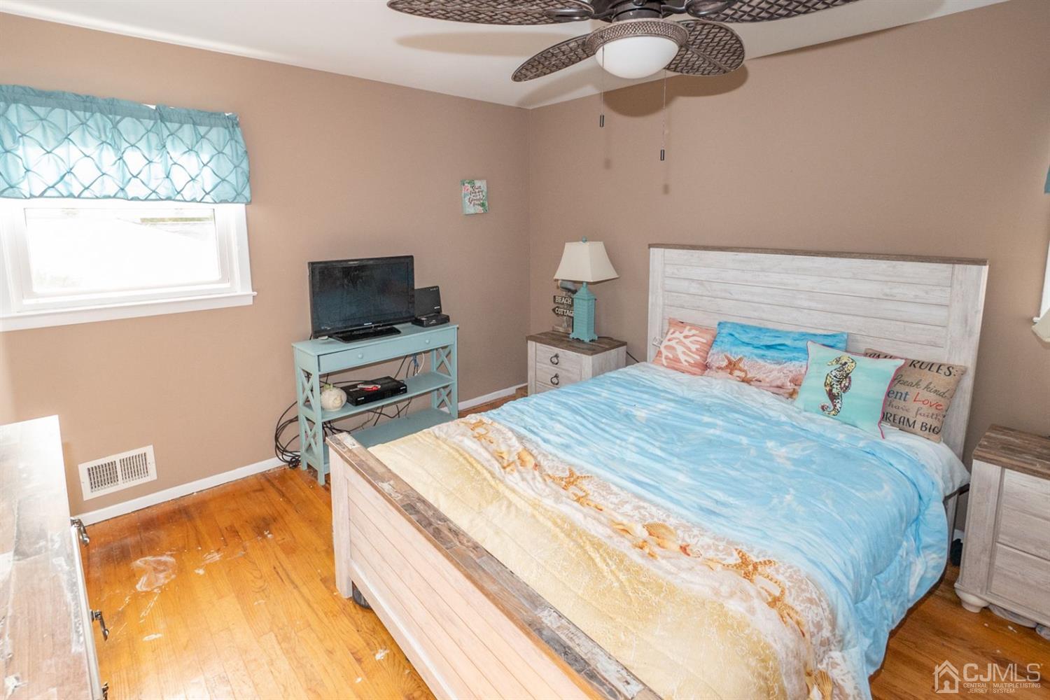 4 Hansen Road Old Bridge, NJ 08857 - Photo 18 of 39 a bedroom with a bed and a flat tv screen on the dresser