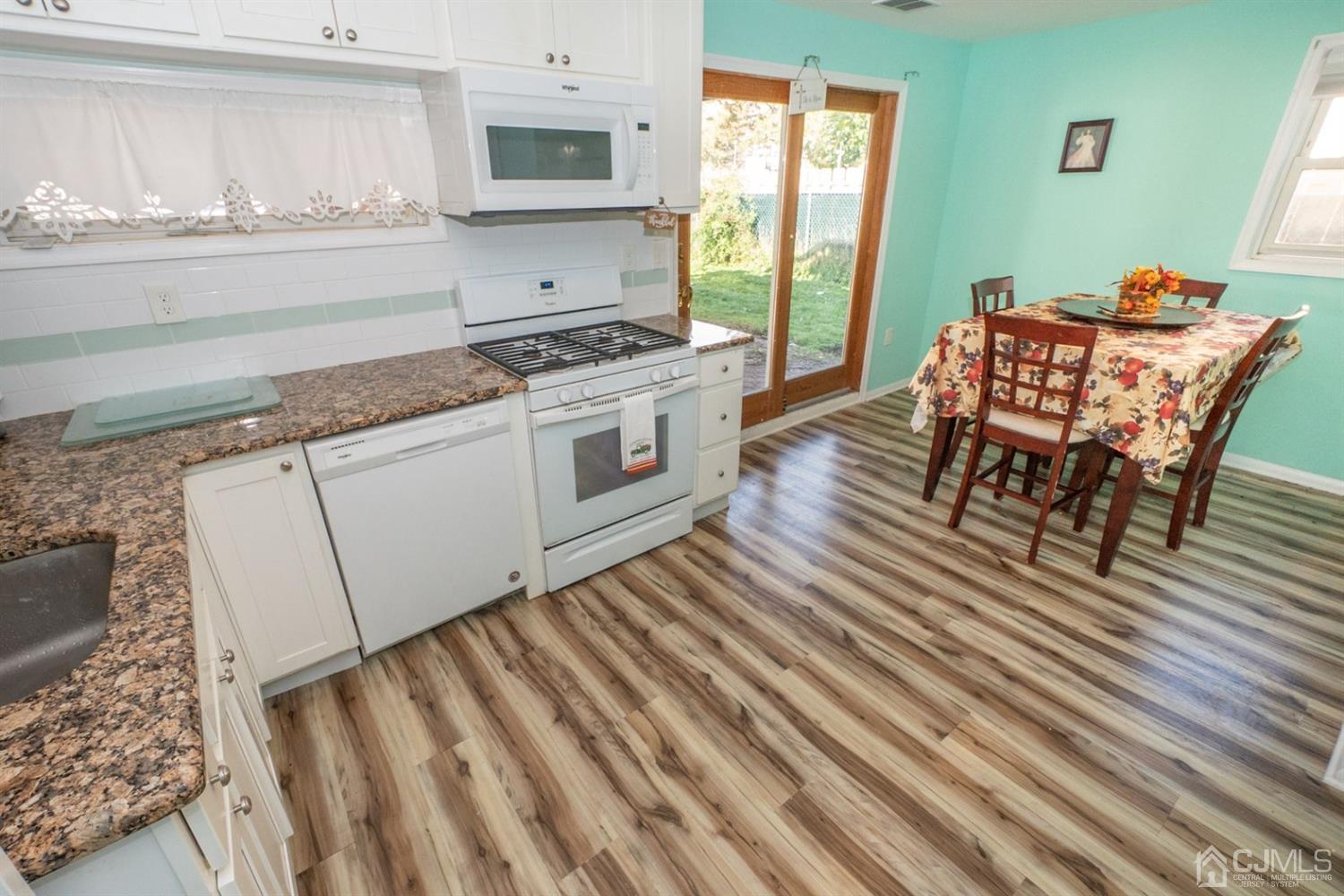 4 Hansen Road Old Bridge, NJ 08857 - Photo 23 of 39 a kitchen with stainless steel appliances granite countertop a stove a sink and a microwave