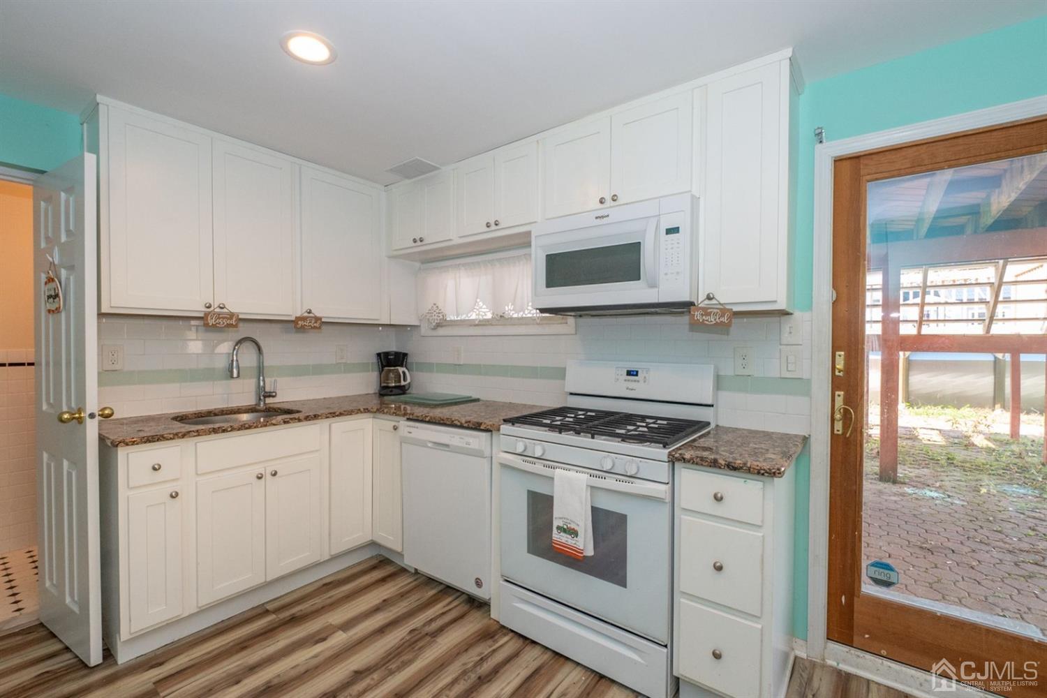 4 Hansen Road Old Bridge, NJ 08857 - Photo 27 of 39 a kitchen with granite countertop a sink a stove and cabinets