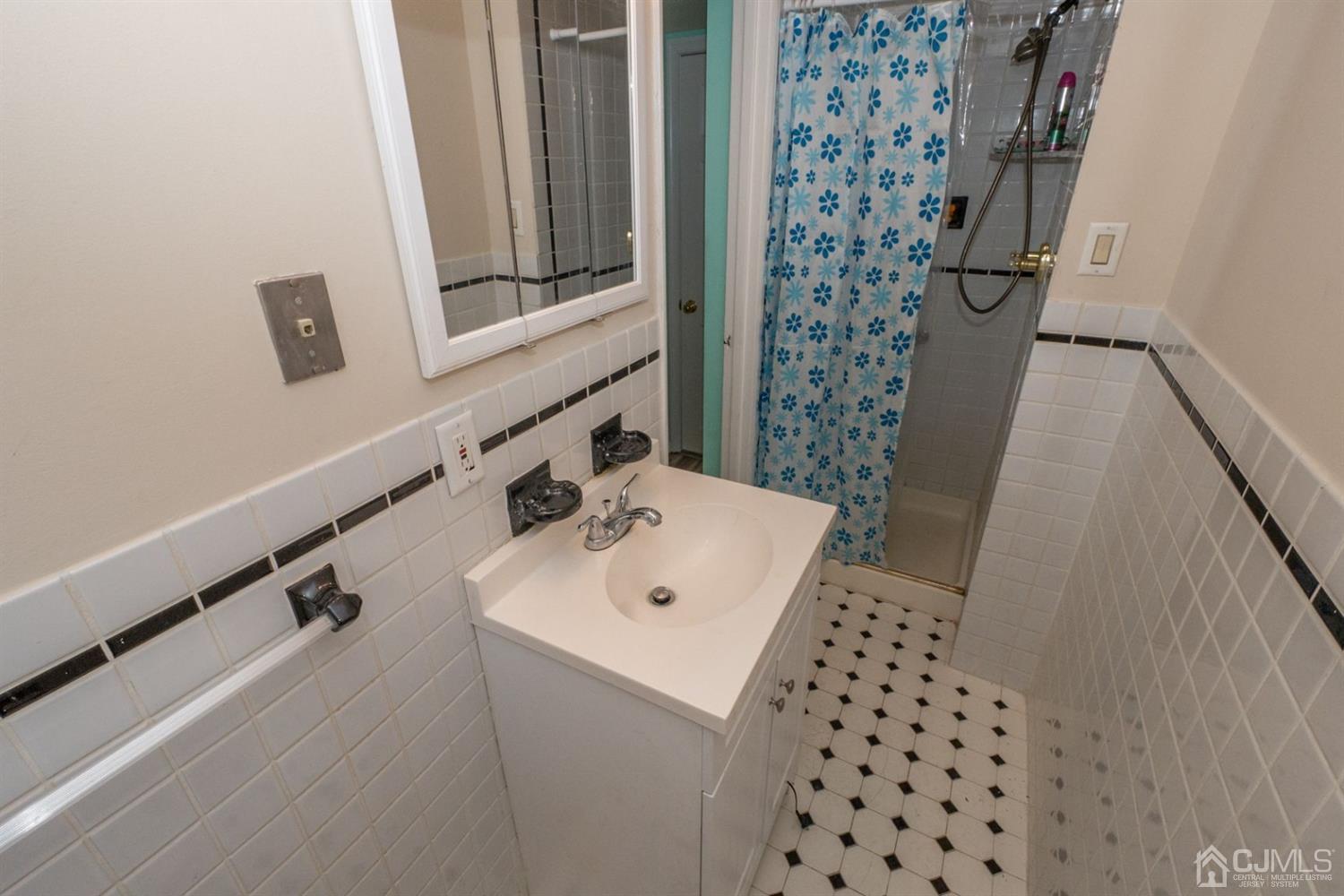 4 Hansen Road Old Bridge, NJ 08857 - Photo 32 of 39 a bathroom with a sink a mirror and shower