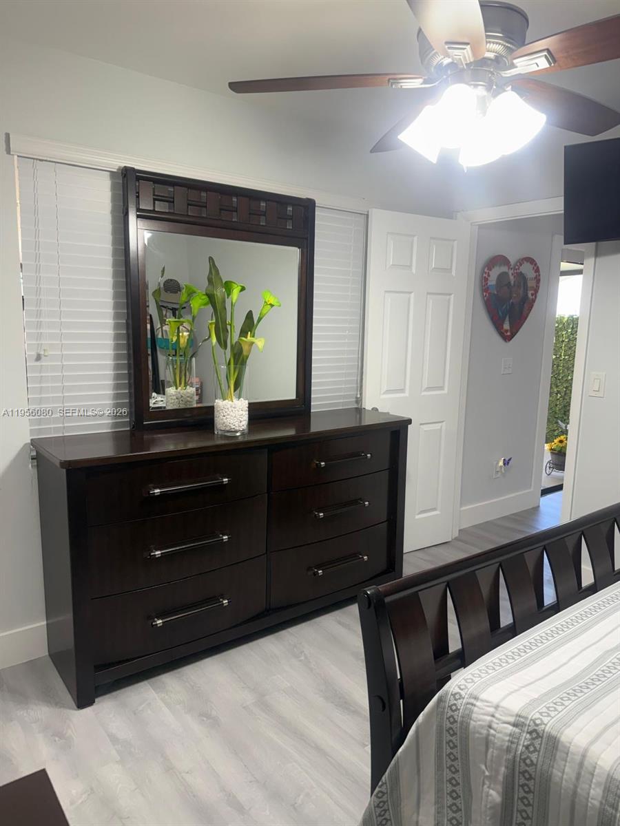 1327 Towhee Street Homestead, FL 33035 - Photo 14 of 31 a bedroom with a bed and a mirror on the dresser
