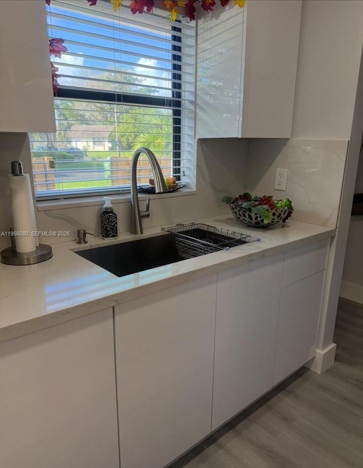 1327 Towhee Street Homestead, FL 33035 - Photo 16 of 31 a kitchen with a sink and wooden cabinets