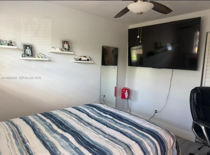 1327 Towhee Street Homestead, FL 33035 - Photo 17 of 31 a bedroom with a bed and flat screen tv