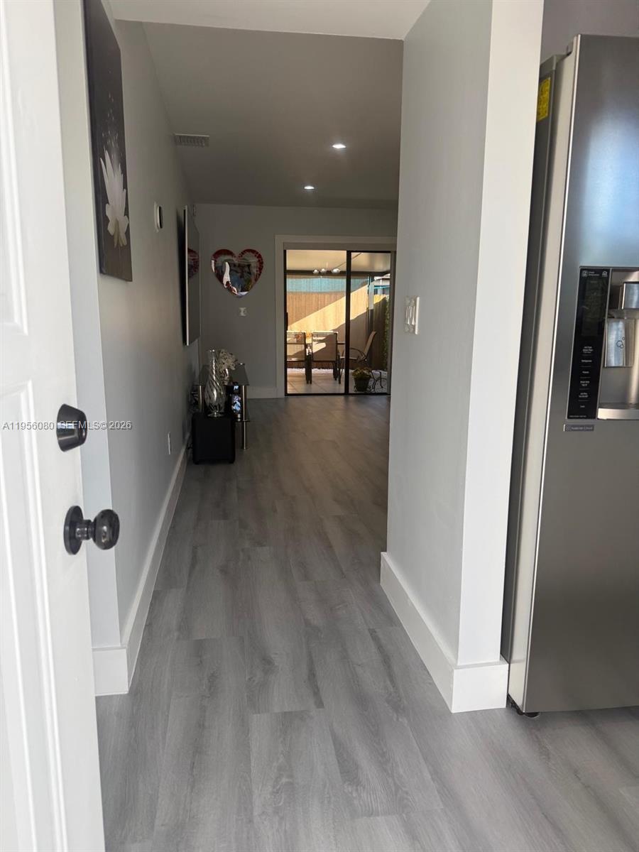 1327 Towhee Street Homestead, FL 33035 - Photo 21 of 31 a view of a hallway with wooden floor and staircase