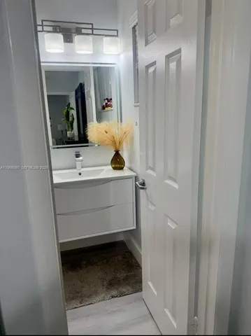 a kitchen with a sink a refrigerator and cabinets