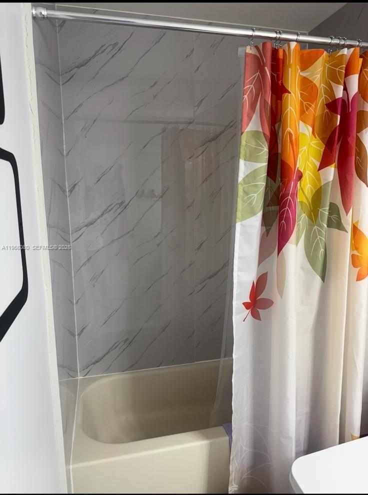 1327 Towhee Street Homestead, FL 33035 - Photo 27 of 31 a bathroom with a bathtub and shower