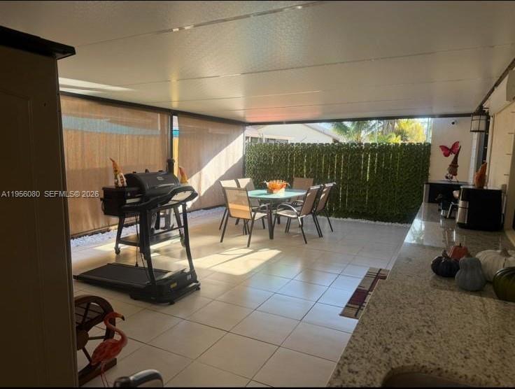 1327 Towhee Street Homestead, FL 33035 - Photo 30 of 31 a dining room with furniture and a floor to ceiling window
