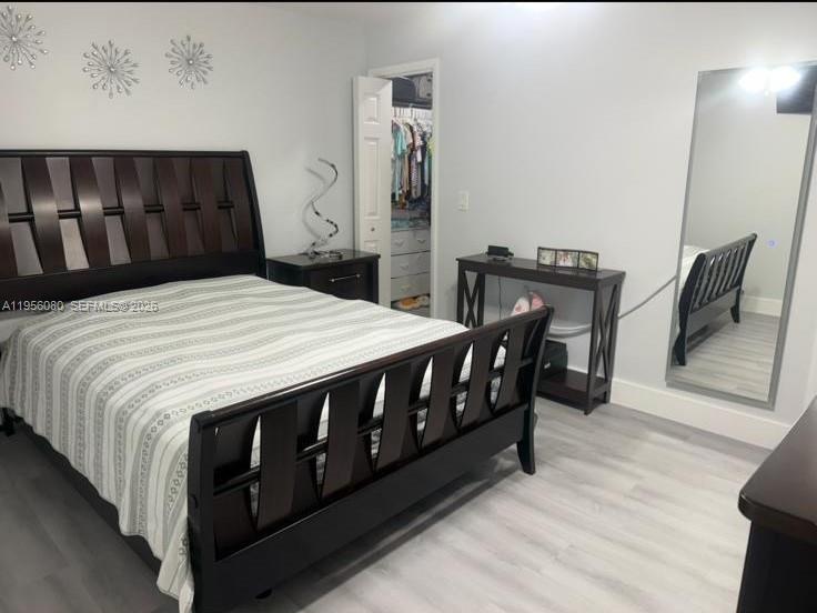 1327 Towhee Street Homestead, FL 33035 - Photo 8 of 31 a bed sitting in a bedroom chandelier