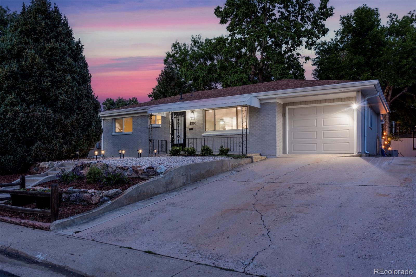 8060 Stuart Place Westminster, CO 80031 - Photo 1 of 18 a front view of a house with garden