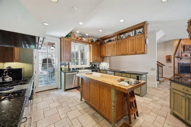 a kitchen with refrigerator a stove a sink and a microwave