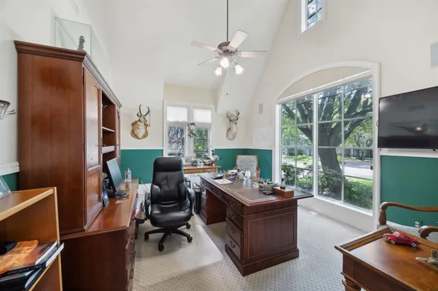 a view of a workspace with furniture and a window