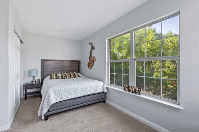 a bedroom with a bed and window