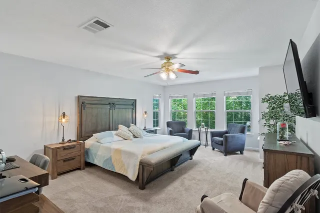 a bedroom with a bed a couch and dresser