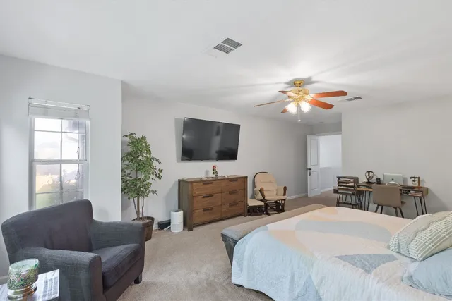 a bedroom with a bed and a couch