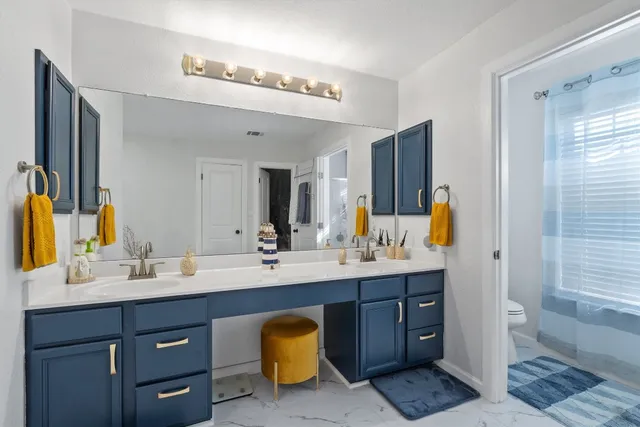 a bathroom with a sink double vanity granite and shower