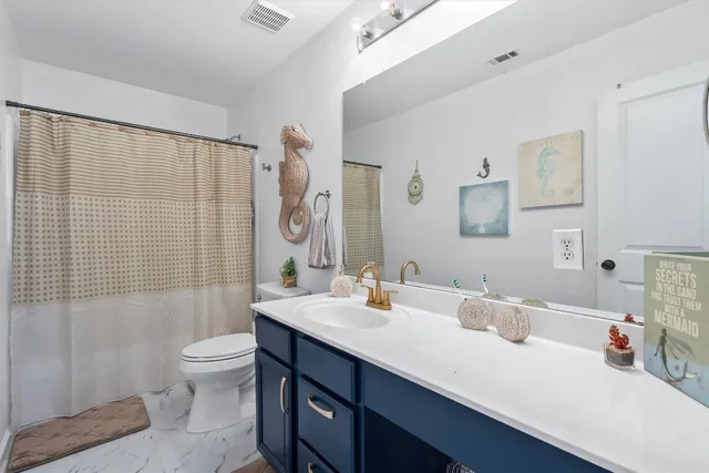 a bathroom with a sink double vanity and toilet