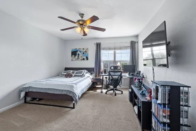 a bed room with a bed and a flat screen tv