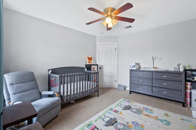 a bedroom with a bed and a couch