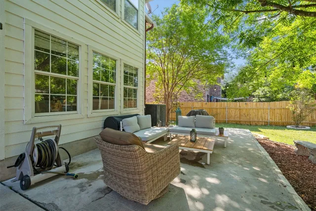 a view of a patio with a chairs and potted plants