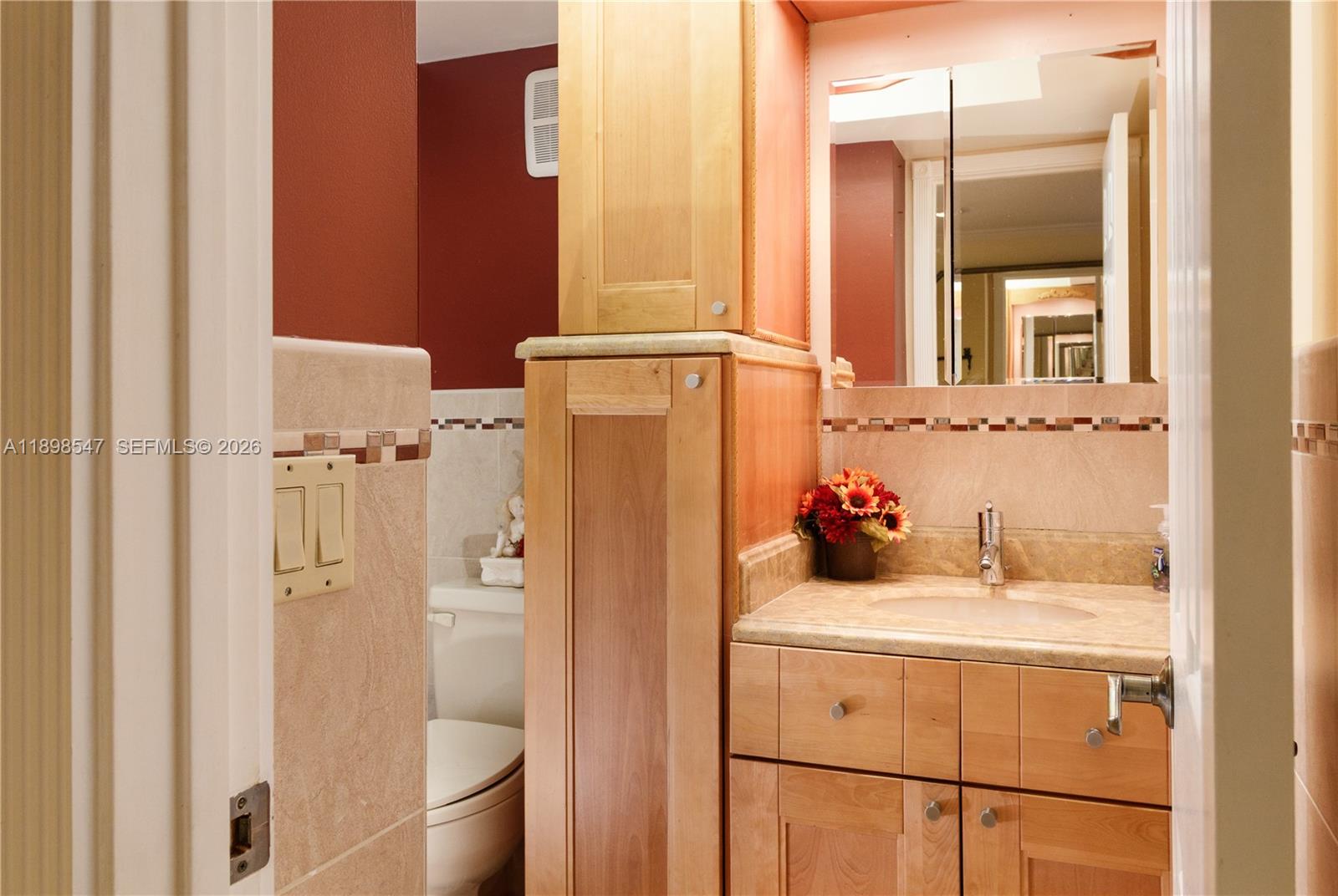 16200 Golf Club Road, Unit 312 Weston, FL 33326 - Photo 13 of 31 a bathroom with a sink and a mirror