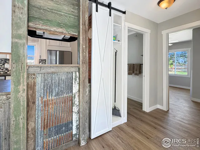 a view of front door and porch with wooden floor