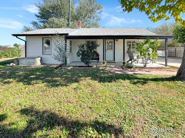 a view of a house with backyard and balcony