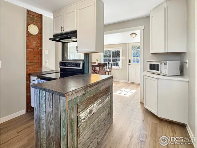 a kitchen with stainless steel appliances granite countertop a stove and a refrigerator