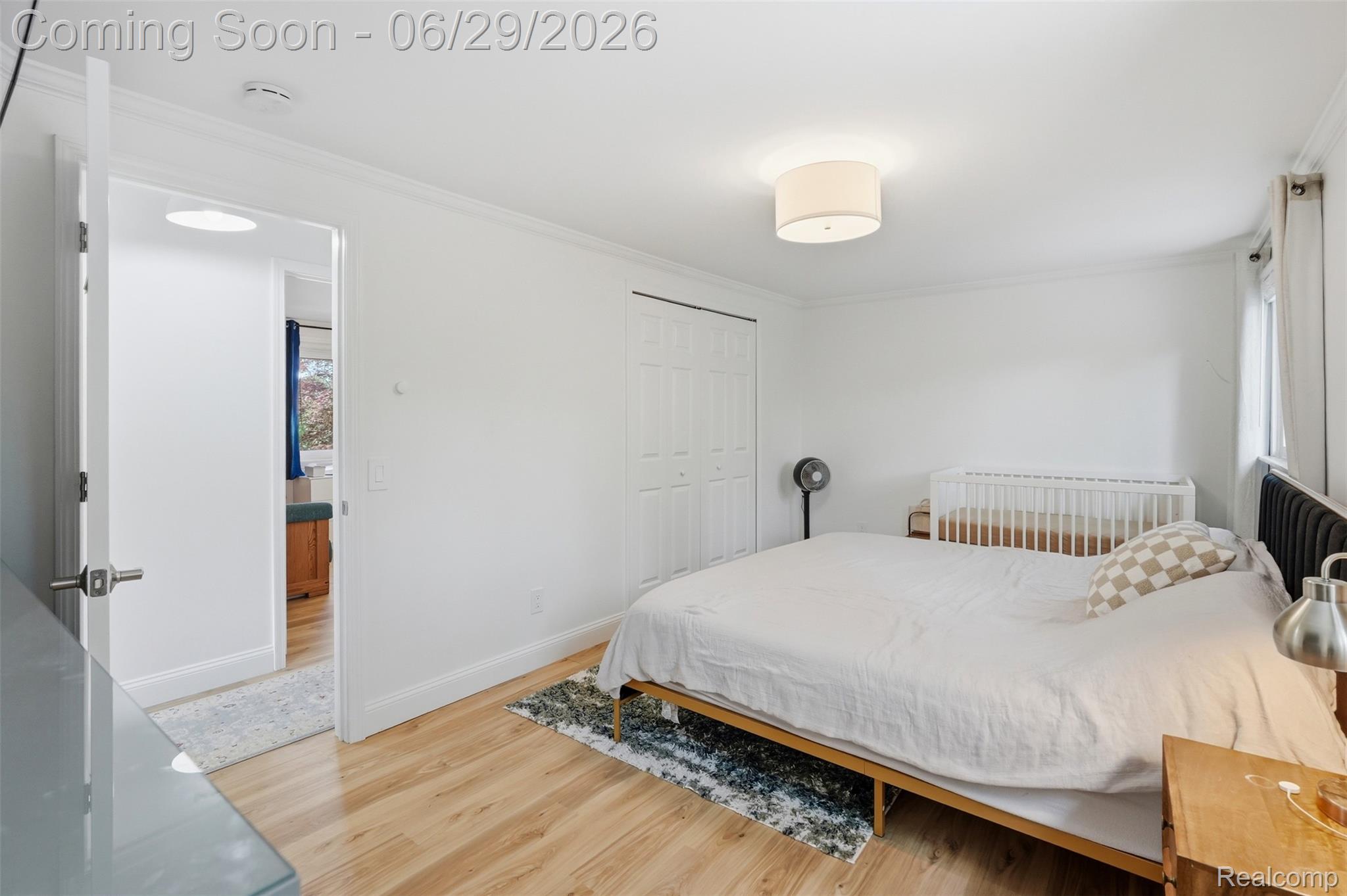 45179 Rudgate Road Canton, MI 48188 - Photo 18 of 48 Well-lit interior space featuring wood-finish flooring, white walls, and a drum-style ceiling light fixture