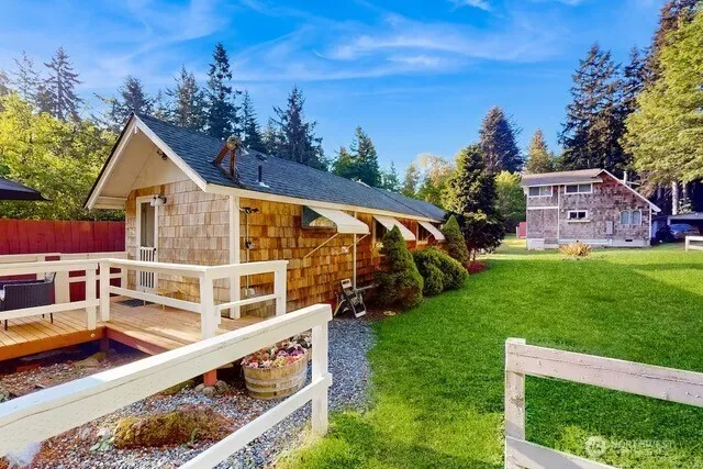 a view of a house with a yard deck and a garden