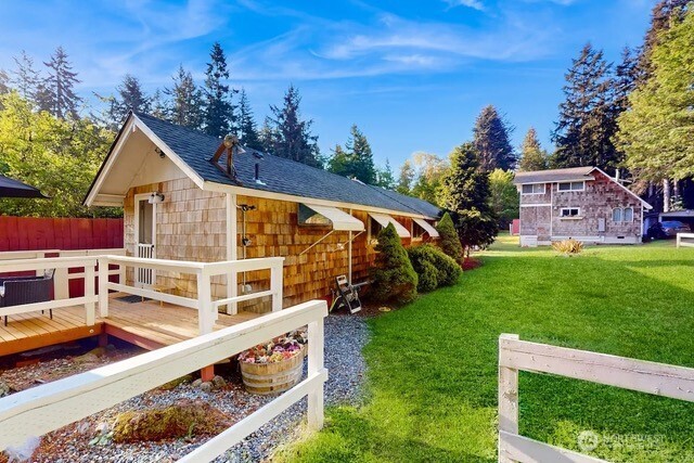 a view of a house with a yard deck and a garden