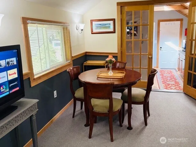 a view of a dining room with furniture and chandelier