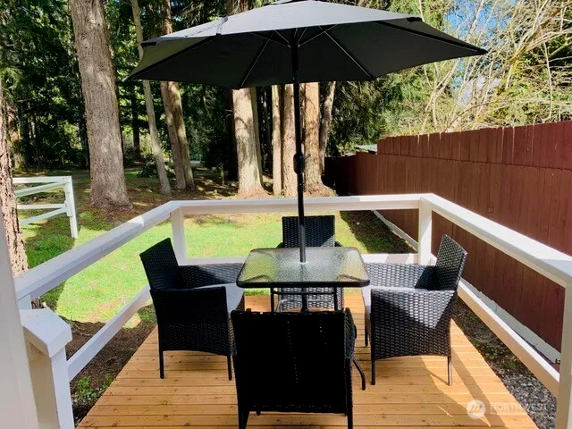 a view of balcony with outdoor seating and wooden floor