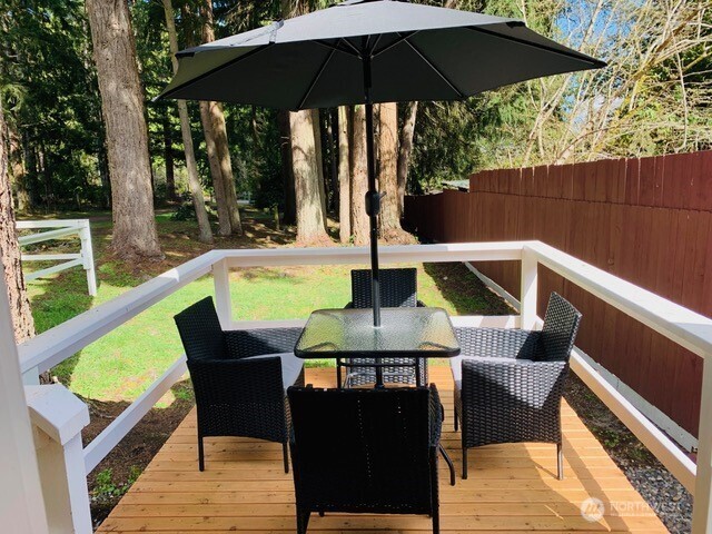 5024 Saratoga Road, Unit STUDIO Langley, WA 98260 - Photo 16 of 17 a view of balcony with outdoor seating and wooden floor