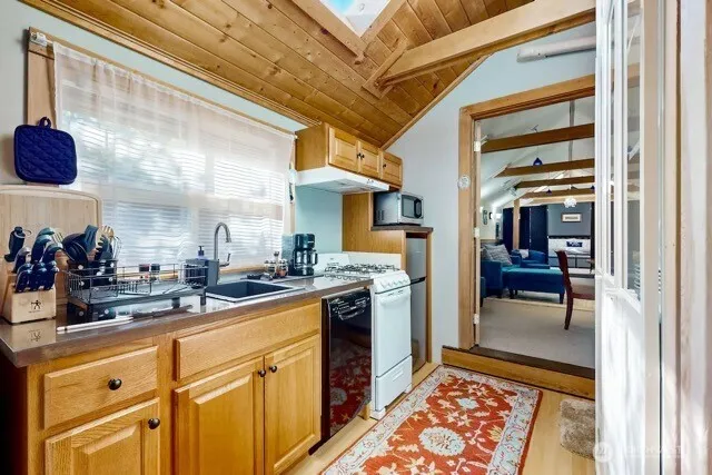 a kitchen with stainless steel appliances granite countertop a sink and cabinets