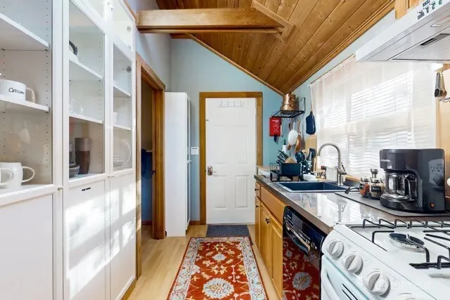 a kitchen that has a sink and a stove