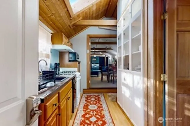 a hallway with a stove and a dining table