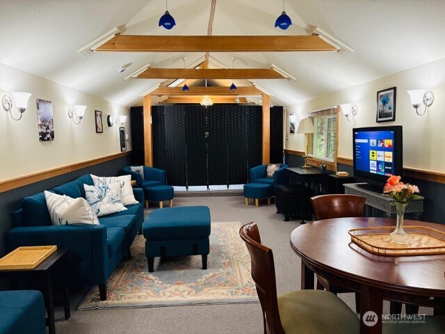 5024 Saratoga Road, Unit STUDIO Langley, WA 98260 - Photo 5 of 17 a living room with furniture and a chandelier